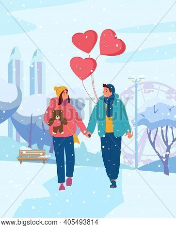 Young Couple Holding Hands With Heart-shaped Balloons Walking In Winter Park. Teenage Couple On A Da