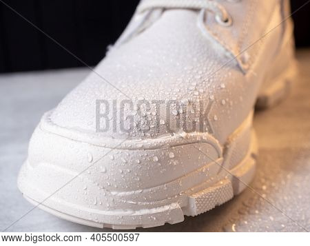 Water Droplets On Winter Shoe Protected With Waterproof Spray