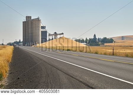 Grain Elevator And Wheat Pile. A Stockpile Of Wheat At A Grain Elevator In Creston, Washington State