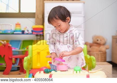 Cute Little Asian 2 - 3 Years Old Toddler Girl Child Having Fun Playing Alone With Cooking Toys, Kit