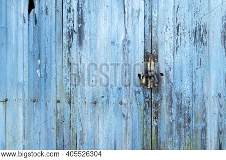 Plank Old Blue Weathered Gate With A Keyhole And A Padlock With Rusted Iron. Copspace