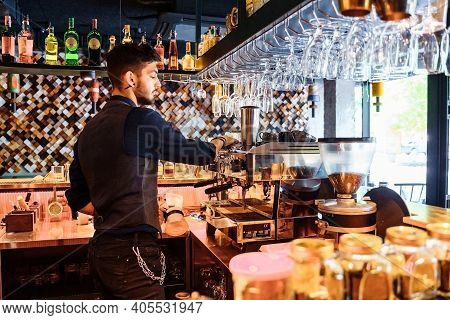 Close-up Of Barista Making Espresso From A Coffee Machine In A Restaurant, Bar Or Pub. Professional