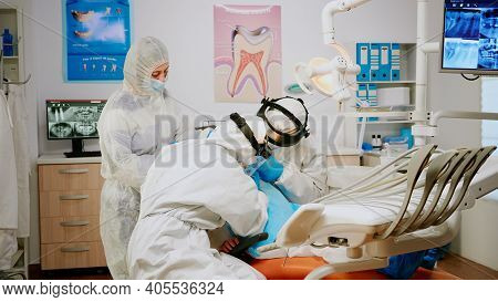 Little Girl Patient Sitting In Dental Chair In New Normal Dentistry Office, Visiting Doctor For Oral