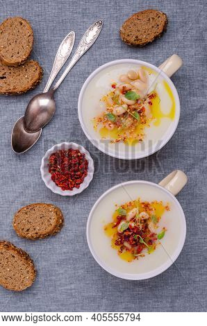 Vegetable Cream Soup With Beans And Spicy Oil In A Bowl On A Textile Background. Selective Focus.