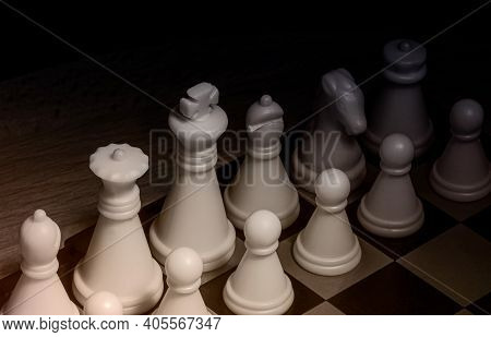 An Image Of Black And White Chess Pieces On A Chessboard.