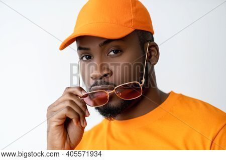Eyewear Fashion. Summer Accessories. Optical Style. Confident African Man In Orange T-shirt Matching