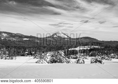 Winter Hilly Landscape Of Lusatian Mountains With Klic Mountain In The Middle. Czech Republic. Black