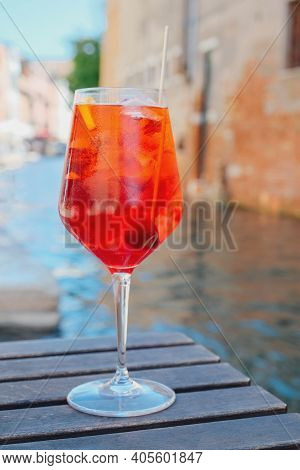Glass Of Refreshing Aperol Spritz Cocktail Served On The Deck Bar In Venice. Traditional Venetian Ap