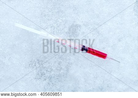 Vaccine In A Syringe With A Needle With A Red Medical Product For Vaccination Against Coronavirus Di