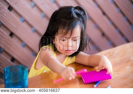 The Kid Girl Cried And Didn't Want To Write A Book. Children Study At Home. An Asian Girl Aged 3 - 4