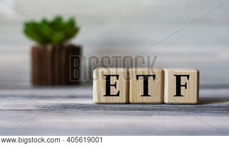 Etf (exchance Traded Fund) - Acronym On Wooden Cubes Against The Background Of A Light Board With Be