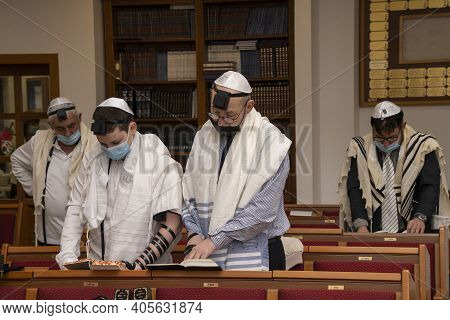 Jerusalem, Israel - January 28th, 2020:people Praying In A Synagogue, Wearing Protective Masks.