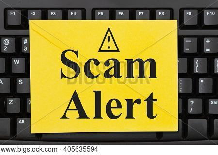 Scam Alert Message On A Yellow Envelope On A Black Keyboard