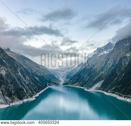 Aerial Drone Shot Of Schlegeisspeicher Resevoir With Galcier View At Dusk