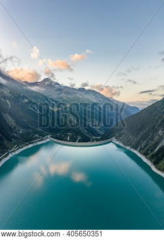 Aerial Drone Shot Of Schlegeisspeicher Resevoir With Galcier View At Dusk