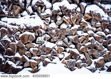 Firewood Pile Covered With Snow In A Forest