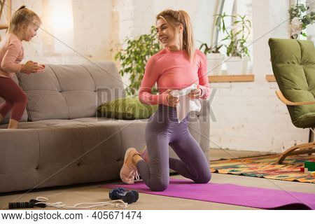 Resting, Laughting Together. Young Woman Exercising Fitness, Aerobic, Yoga At Home, Sporty Lifestyle