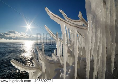 Frozen Splashes On Brunches Of Trees On The Coast Of Baikal Lake With Sunpath On Water