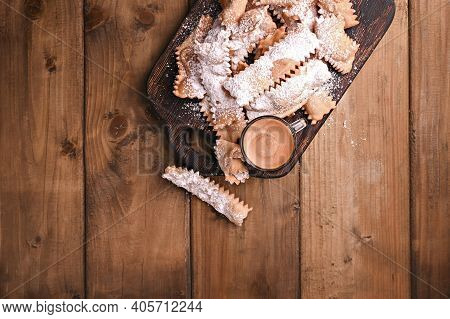 Carnival Food Typical And Aromatic Coffee On A Woody Background View From Above. Sfrappole Or Chiach