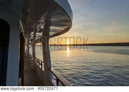 Beautiful And Spectacular Sunset Over A Motor Yacht With Reflections On The White Paint And Details 