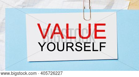 Text Value Yourself On A White Card On A Blue Background. Business Concept