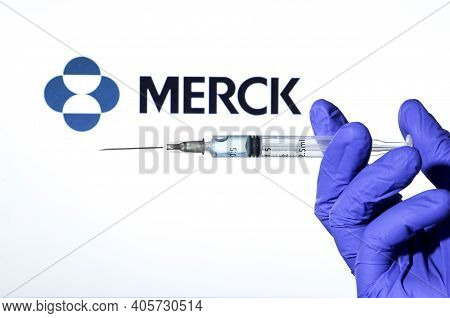 Madrid, Spain- January 7, 2020: Hand On Blue Surgery Glove Holding Syringe With Covid Vaccine. In Th
