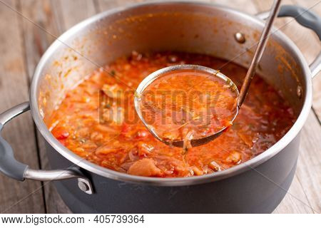 A Ladle Of Borscht. Ukrainian Borsch. Saucepan With The Ukrainian National Dish Soup Borscht.
