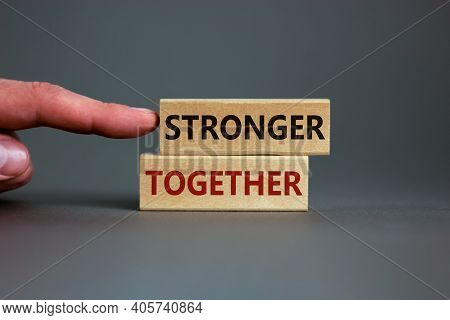 Stronger Together Symbol. Concept Words 'stronger Together' On Wooden Blocks On A Beautiful Grey Bac