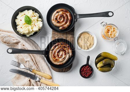 Fried Bavarian German Nürnberger Sausages With Sauerkraut, Mashed Potatoe In Cast Iron Frying Pan, O