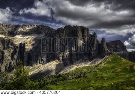 Infrared Landscape Of Group Of Sella In Summer Season With Dark Clouds In The Sky