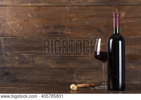 Bottle Of Wine And Glasse. There Is A Corkscrew And A Cork Nearby. Soace For Text.