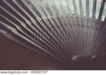Traditional Black Hand Fand Closeup View. Abstract Background