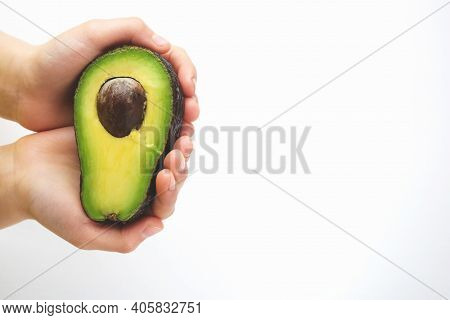 In The Hands Of A Green Avocado. Avocado Close-up. Natural Fresh Organic Exotic Fruits. Healthy Food