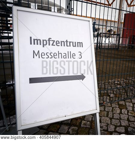 Directional Arrow To A Vaccination Center On The Outskirts Of The City Of Magdeburg In Germany. Sign