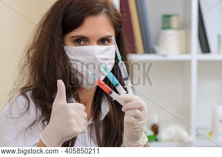 Young Nurce Holding Many Syringe With Medication