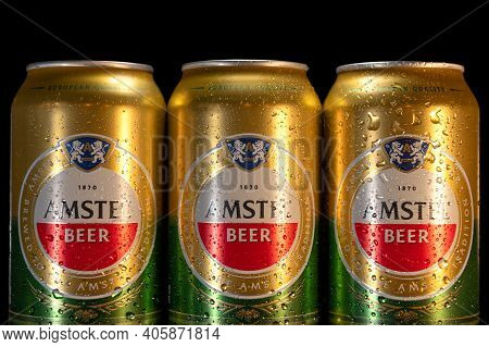Rivne, Ukraine - January 12, 2021: Amstel Beer Cans Close Up On A Black Background, Amstel Is The Mo