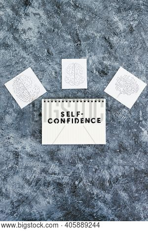 Self-confidence Taxt On Notepad Surrounded By Brain Icons Symbol Of Mind And Mindset Shift, Psycholo