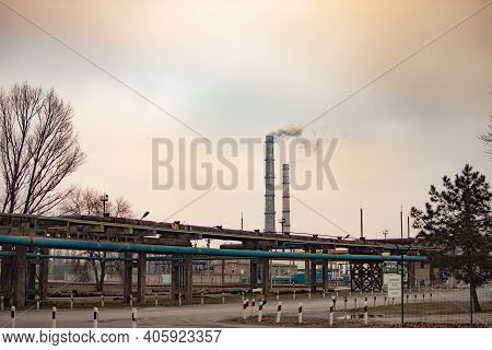 Industrial Zone With A Large Two Pipes Smoke Is Poured From The Factory Pipe. Pollution Of The Envir