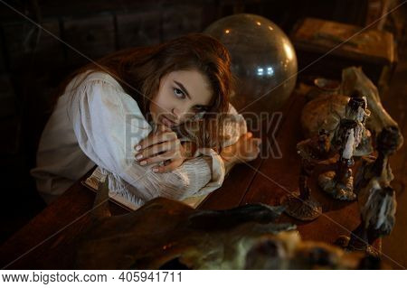 Crazy demonic woman sitting at the table, exorcism