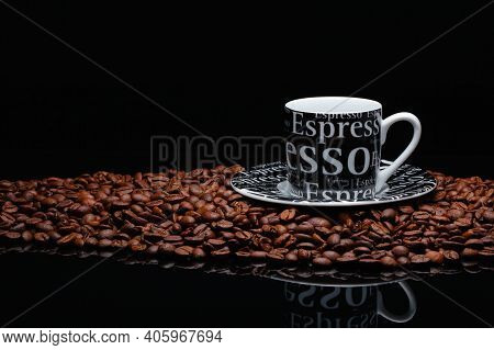 Coffee Mug On A Pile Of Coffee Beans On The Black Background.