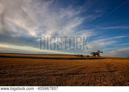 On The Empty Field After Harvesting In Summer Evening. Czech Republic. Amazing Sunset In Czech Bohem