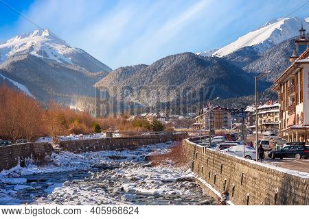 Bansko, Bulgaria - January 28, 2021: Glazne River In Bulgarian Town, Hotel Houses And Snow Pirin Mou