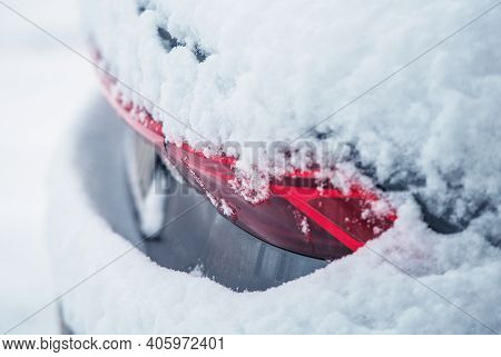 Rear Side Of Modern Car Covered By Fresh Winter Snow. Close Up Photo. Automotive Winter Season Maint