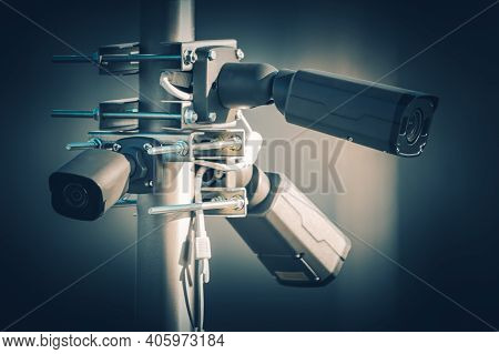 Three Modern Security Megapixel Cctv Cameras Installed On Aluminium Outdoor Pole. Closed Caption Tel