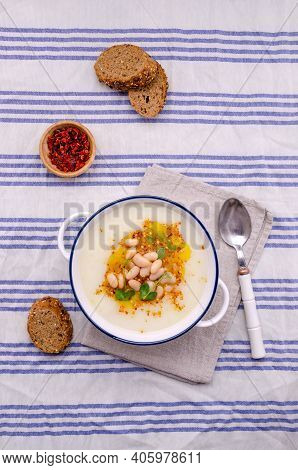 Vegetable Cream Soup With Beans And Spicy Oil In A Bowl On A Textile Background. Selective Focus.