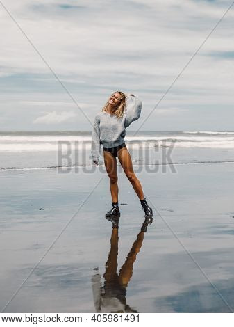Attractive Happy Woman In Sweater Posing At Ocean Beach