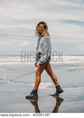 Attractive Cheerful Woman In Sweater Posing At Ocean Beach