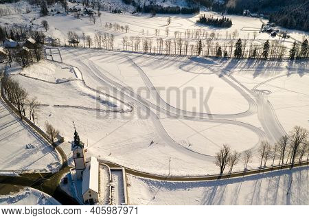 Aerial Winter Landscape With Mountain Village And Forest Covered In Snow. Zgornje Jezersko, Slovenia