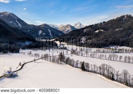 Aerial Winter Landscape With Mountain Village And Forest Covered In Snow. Zgornje Jezersko, Slovenia