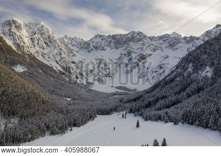 Aerial Winter Landscape Mountain Valley With Forest Covered In Snow. Zgornje Jezersko, Slovenia.